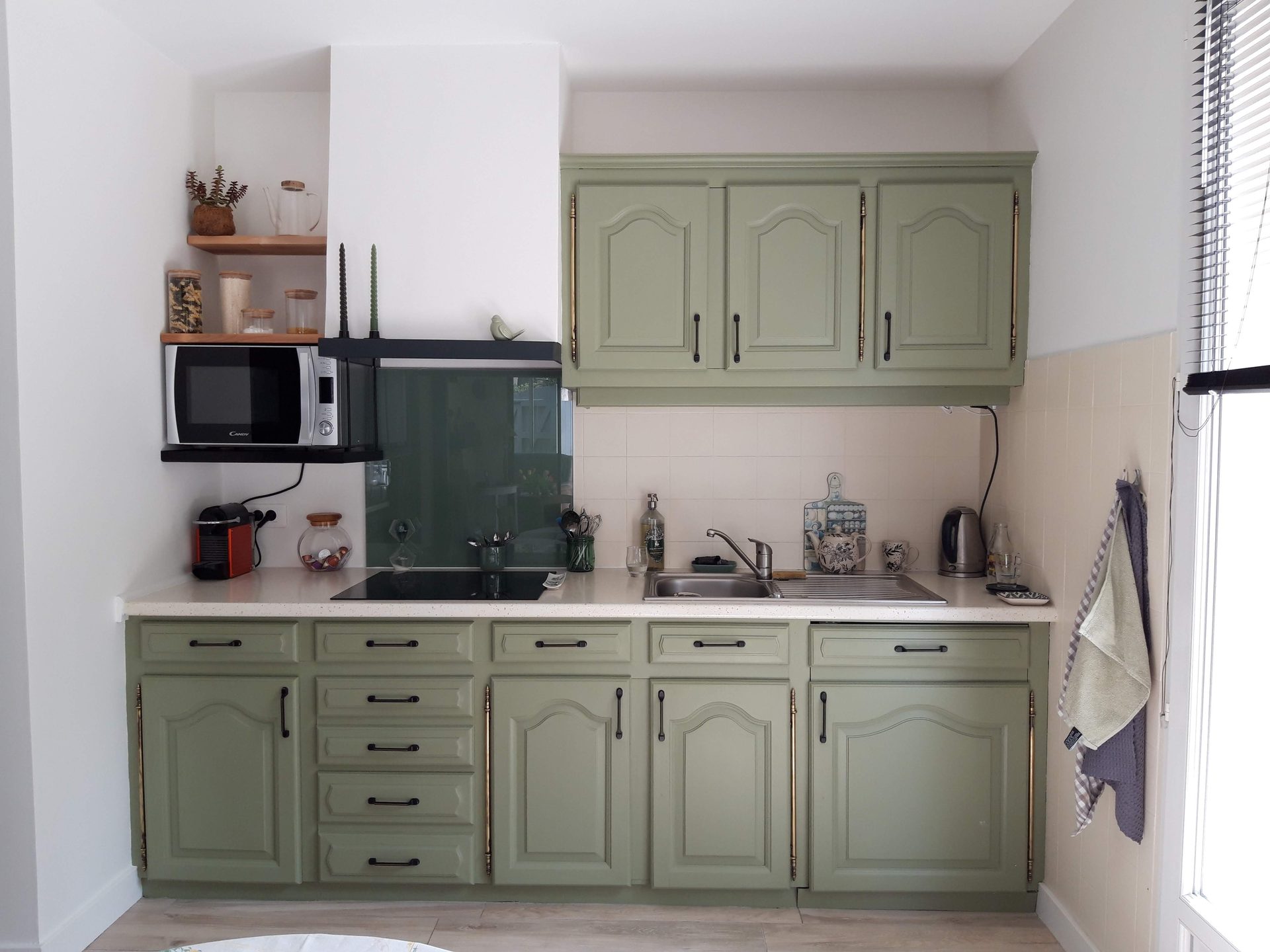 Cuisine bicolore — meubles vert sauge, poignées noires