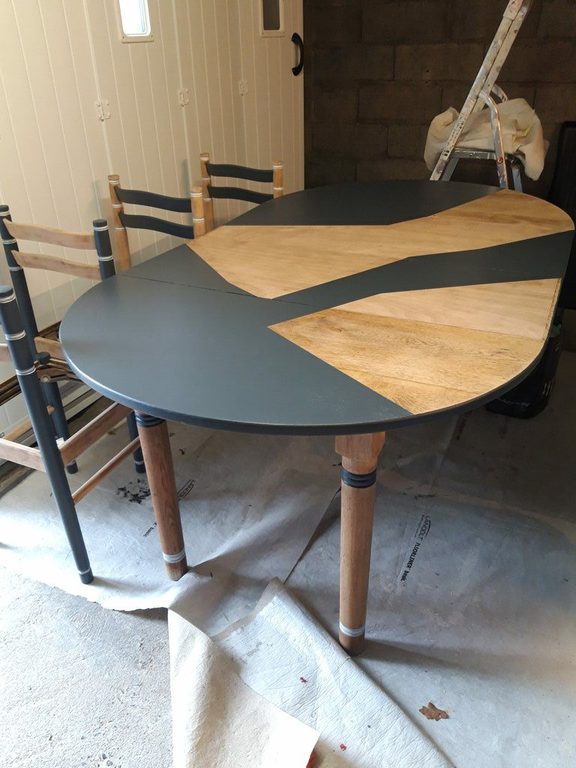 Table ovale au plateau gris ardoise, éclats de bois clair laissés apparents
