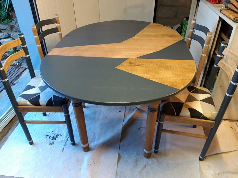 Table ovale et chaises à barreaux dans l'atelier